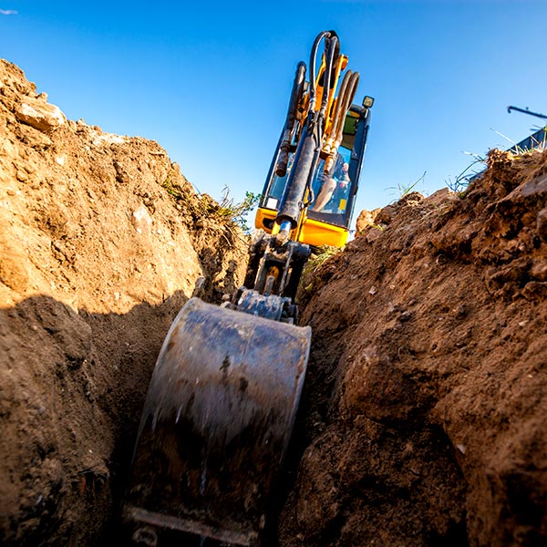 crane bucketing the sand on site
