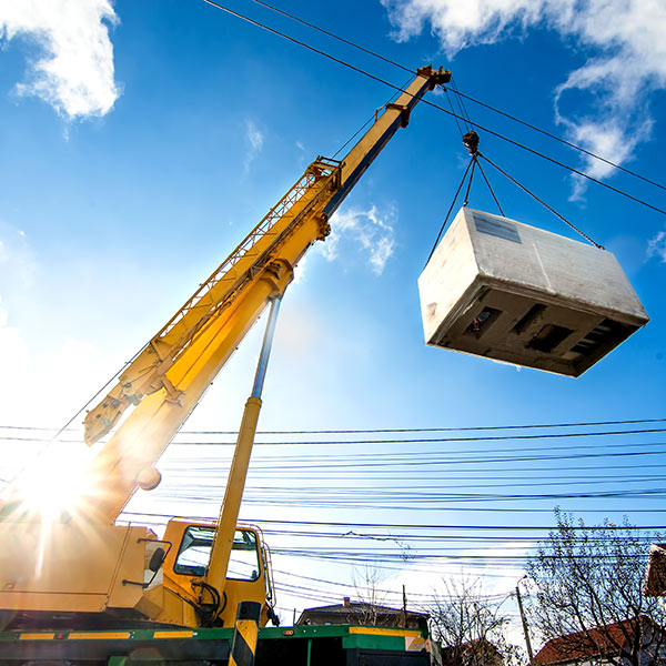 crane lifting heavy material and unloading